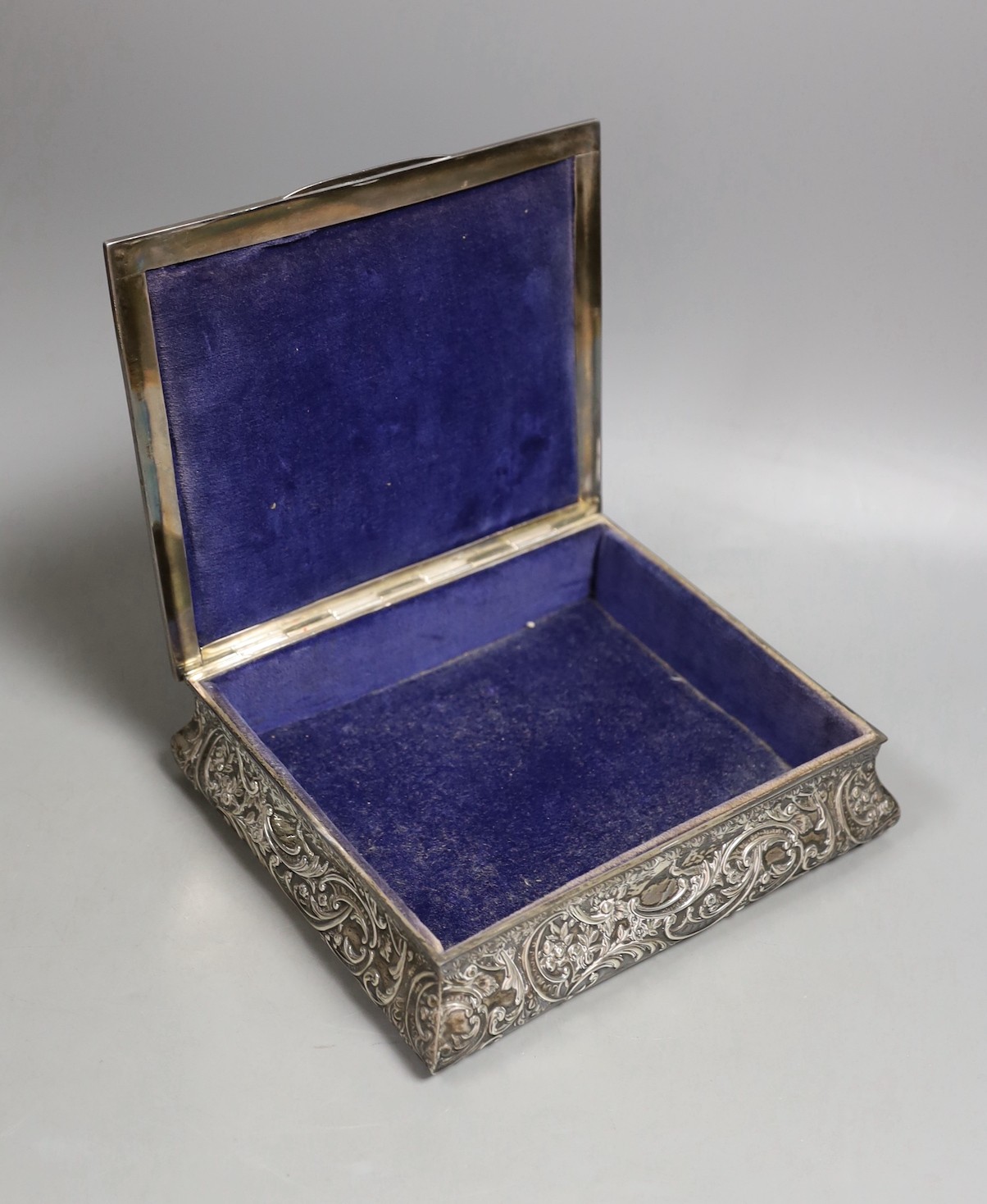 An Edwardian embossed silver mounted rectangular bombe shaped jewellery casket, Henry Matthews, Birmingham, 1905, 19.2cm.